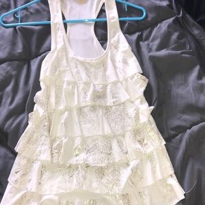 A cream and gold flared tank top.